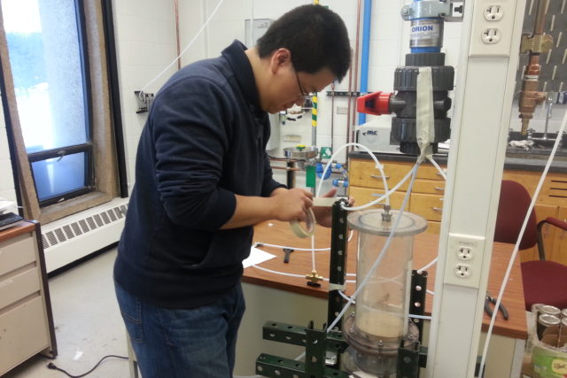 student working with lab equipment